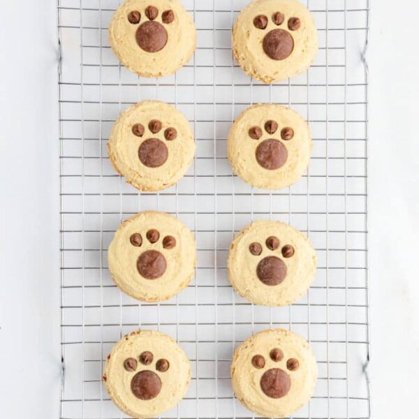 Bear Paw Cookies rest on a cooling rack, each decorated with a charming paw print design.